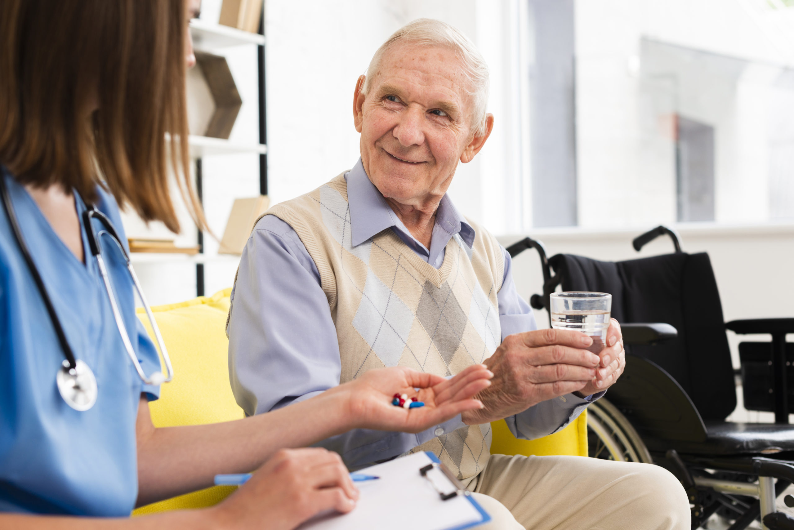 nurse-giving-pills-smiley-old-man